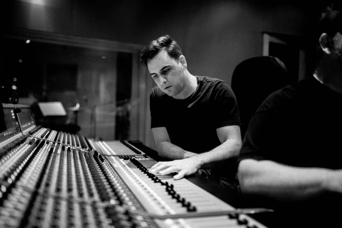 Aaron Newberry working at a recording console in the studio