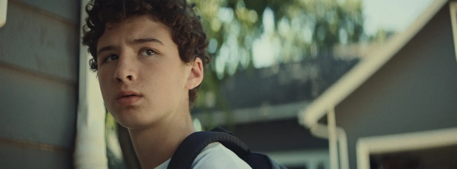 A boy caught in a doorway, a film still from Lost Kings